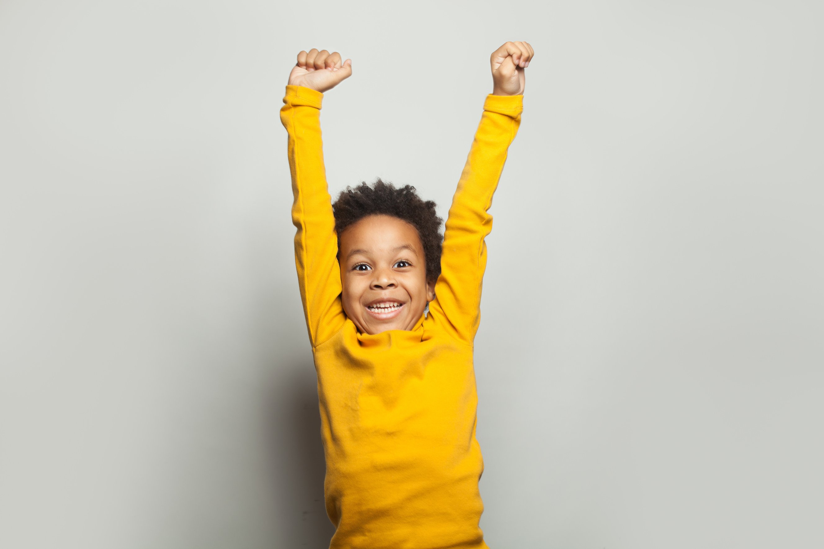 Little black child win-win! Kid boy having fun on white background